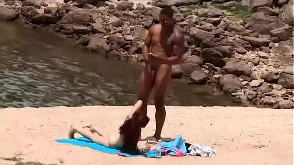 Black dude looks for horny babes at the nude beach and bangs one of 'em